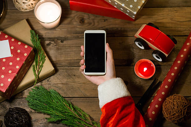 istock Santa use smart phone with a copyspace for Christmas 621252800