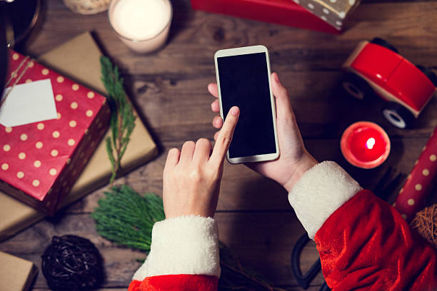 istock Santa use smart phone with a copyspace for Christmas. 621252884