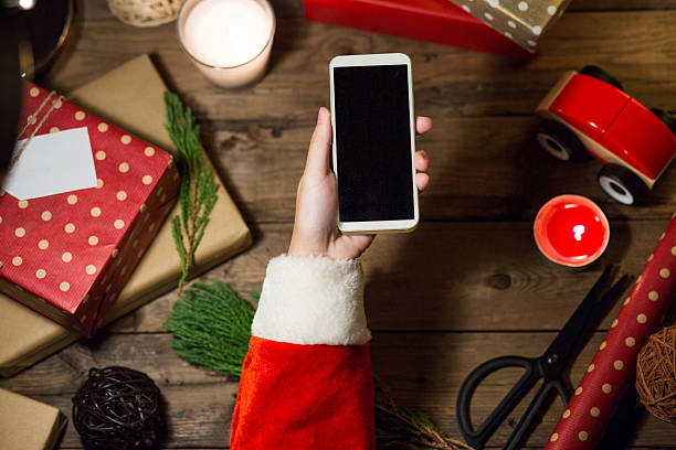 istock Santa use smart phone with a copyspace for Christmas. 621252922