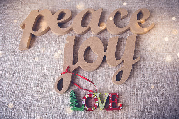 istock Peace joy love on holiday fairy light toning background 621253980