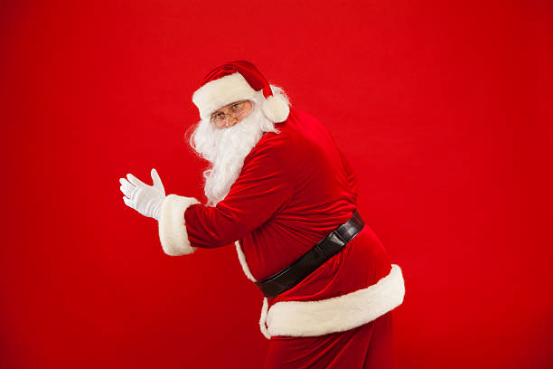istock Running Santa Claus red background Merry Christmas. 621254610