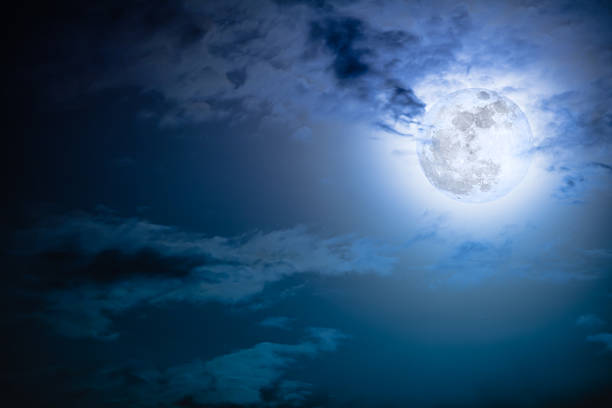 istock Nighttime sky with clouds and bright full moon with shiny. 621255200