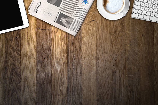 istock Daily newspaper and tablet pc on the wooden table. 621255252