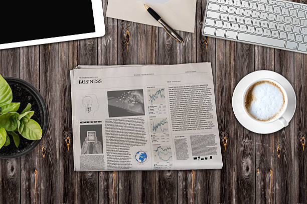 istock Daily newspaper and tablet pc on the wooden table. 621255284