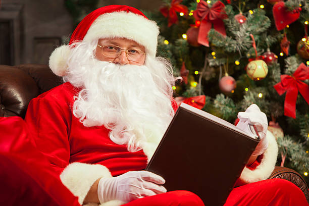 istock Santa Claus sitting at his home in a comfortable chair 621255324