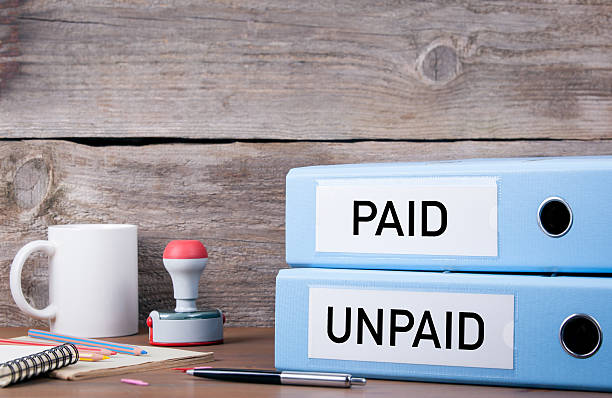 istock Paid and Unpaid. Two binders on desk in the office 621257150