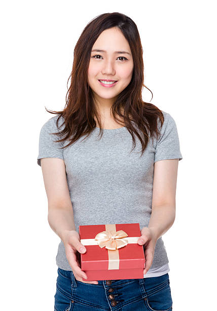 istock Woman holding a gift box 621257456