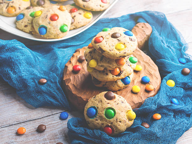 istock Chocolate chip cookies with rainbow candies. Toned 621258982