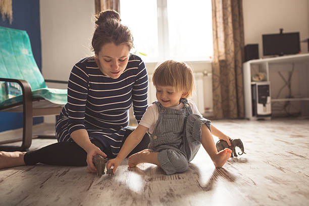 istock young pregnant mother and son playing on floor, lifestyle, 621259310