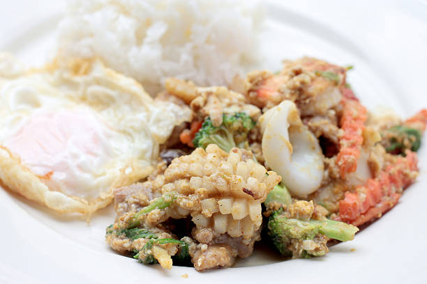 istock Stir-fried Soft-shelled seafood in curry powder & Thai jasmine rice 621259648