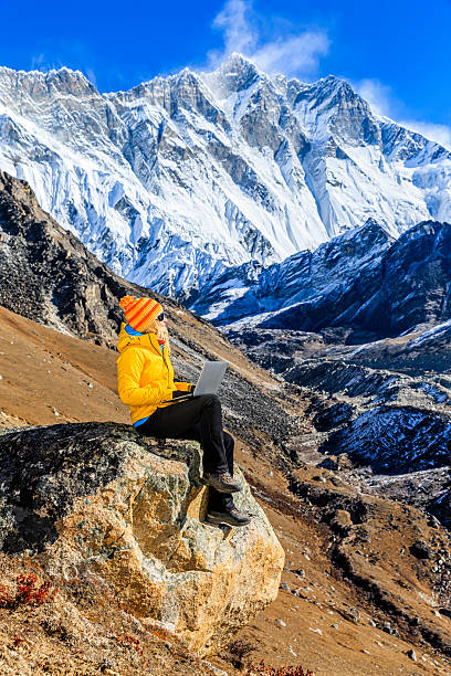 istock Young woman using laptop in Himalayas, Nepal 621259788