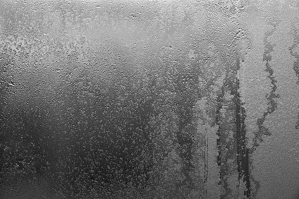 abstract texture of wet glass black gray color abstract background and brilliant texture of black gray color of wet glass with drops of water and with frost or with hoarfrost frost on glass stock pictures, royalty-free photos & images