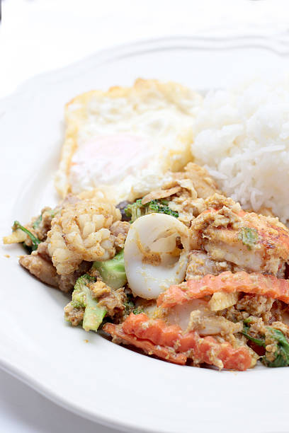 istock Stir-fried Soft-shelled seafood in curry powder & Thai jasmine rice 621260904