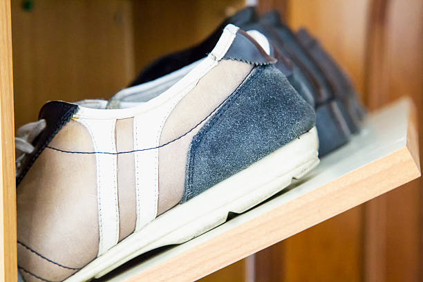 istock Shoes on shoe rack 621261910