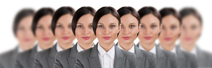 Group of business women clones standing in a row on a white background