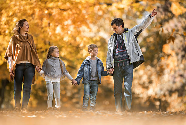 istock Family taking a walk during autumn day in nature. 621263148