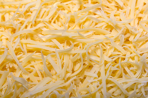 Grated pizza cheese Heap of Grated pizza cheese close up texture shredded mozzarella stock pictures, royalty-free photos & images