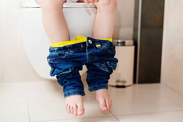 istock Little 7 years old boy on toilet. 621264582
