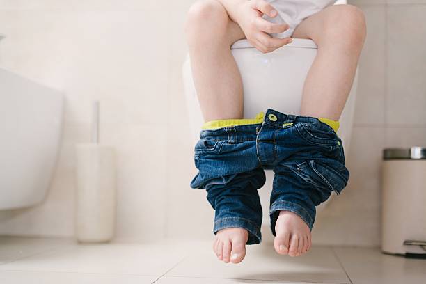 istock Little 7 years old boy on toilet. 621264800