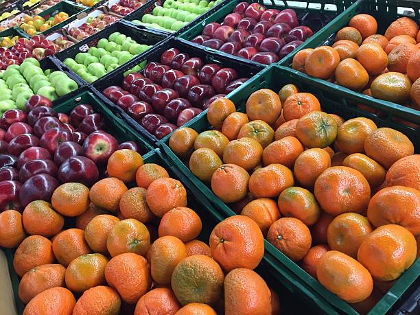 istock Tangerines and apples at market 621264964