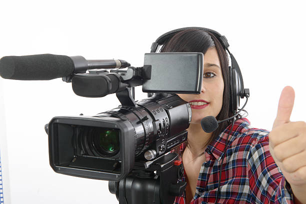 istock pretty young brunette girl with a professional camcorder, on whi 621267430