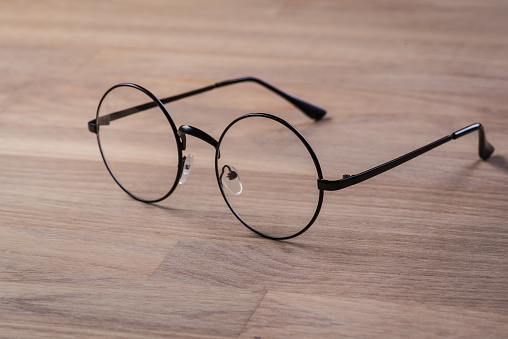 Vintage reading glasses on the wooden table