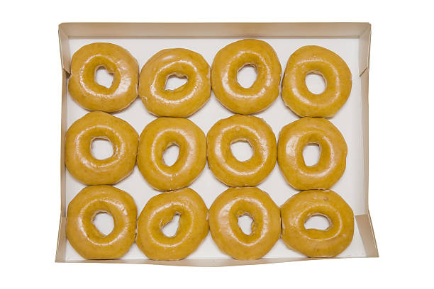 istock box of fresh classic donuts isolated on white background 621268850