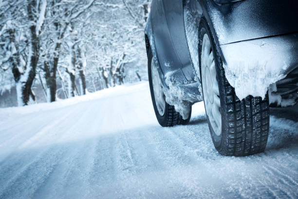 istock Car tires on winter road 621269328
