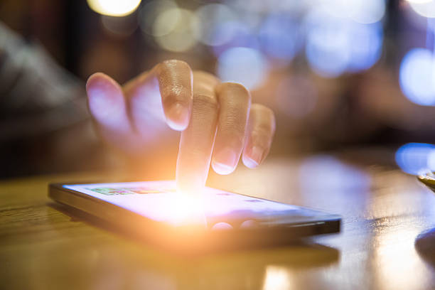 istock close-up Woman using mobile phone in cafe 621269340