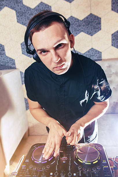 istock Young man DJ with mixer is working 621270286
