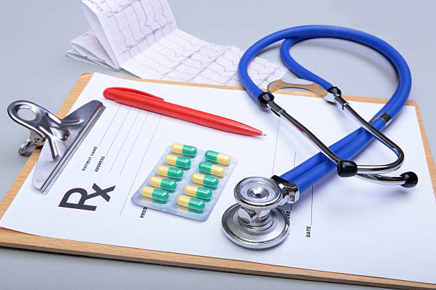 istock Stethoscope head and silver pen lying on cardiogram  clipboard 621270452