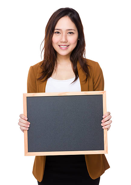 istock Businesswoman holding chalkboard 621270486