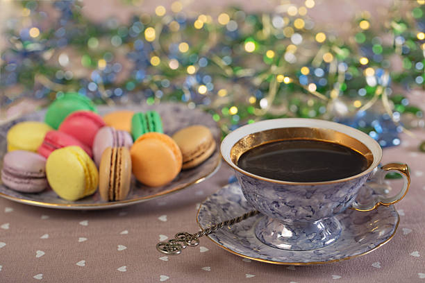 istock Cup of coffee with colorfull macaroons on a table 621271320