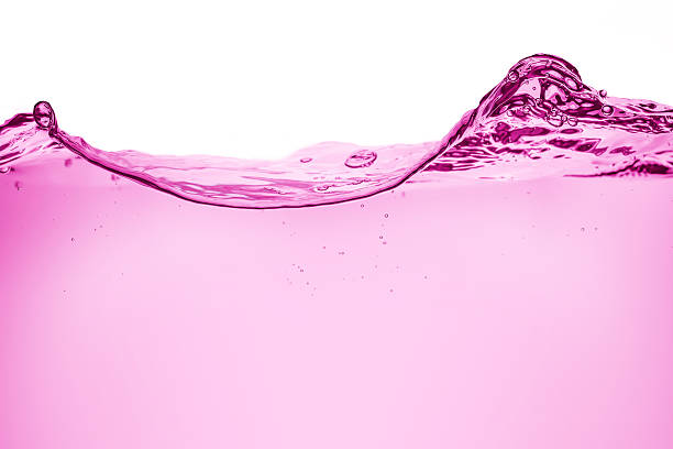 pink wave of liquid on white background stock photo