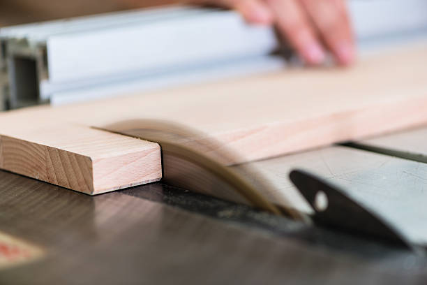 istock Carpenter cutting wooden board with circular saw 621272844