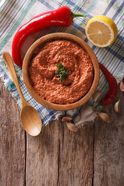istock Red Muhammara and ingredients. Vertical top view 621274344