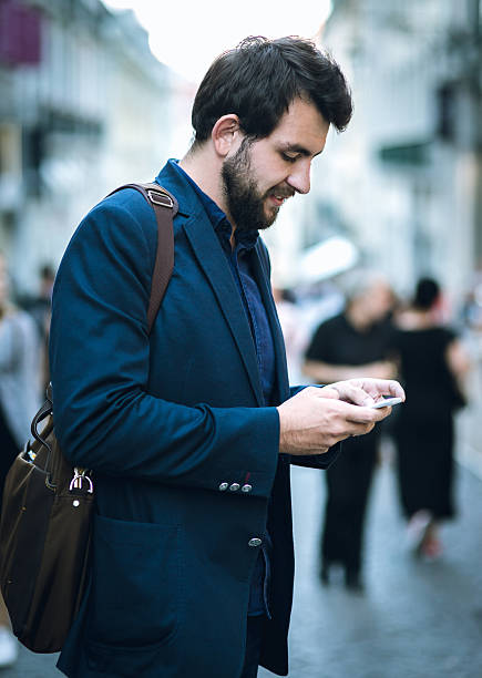istock Businessman using smartphone on the european street 621274694
