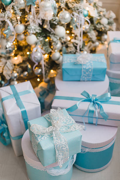istock Christmas gift boxes with blue bow and bokeh lights on 621349306