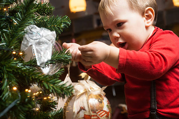 istock Cute Little Child Decorating Christmas Tree 621349542
