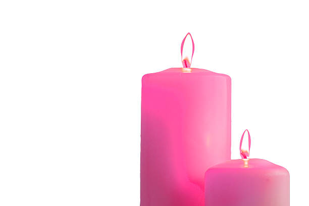 istock Two pink burning candles on white background 621350286