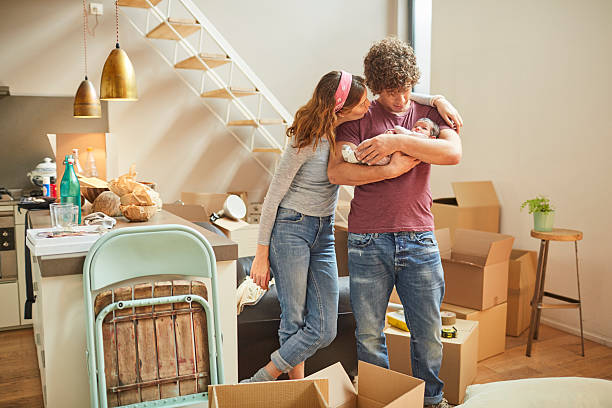 Moving home new beginnings. Couple with baby.