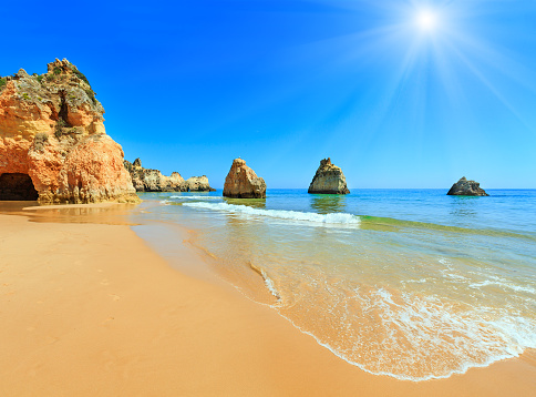 Sandy sunshiny beach Dos Tres Irmaos summer view (Portimao, Alvor, Algarve, Portugal).
