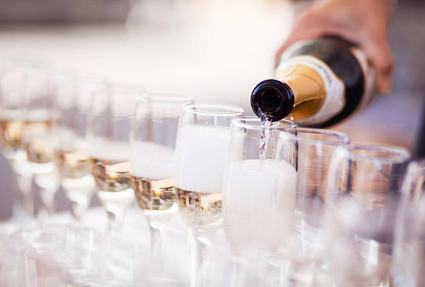Champagne glasses Waiter serving a glass of sparkling white wine pouring stock pictures, royalty-free photos & images