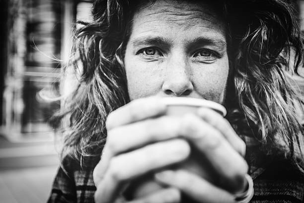 Woman in her forties warming her hands on coffee cup