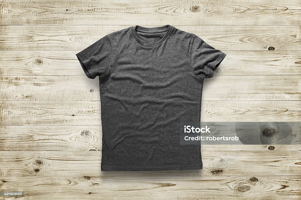 shirt Grey shirt over wood backgroundGrey shirt over wood background T-Shirt Stock Photo
