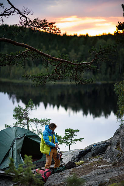 istock Climber having a camp on top of a cliff. 621354854