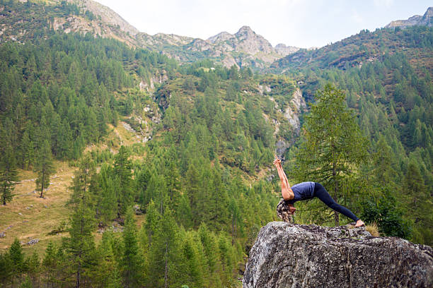 istock Yoga exercises in nature: Warrior pose 621356034