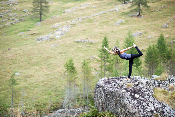 istock Yoga exercises in nature: Dancer pose 621356656