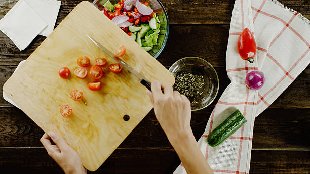 istock cutting tomatos for greek salad 621357124