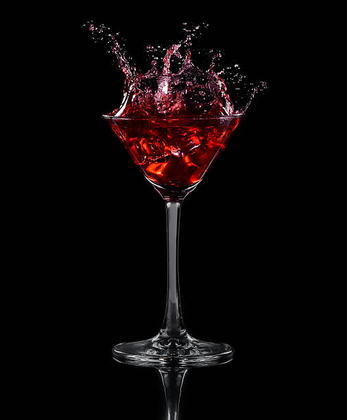 istock Ice cube dropped into a glass of grape juice 621358166